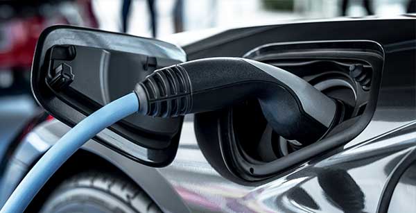 Electric vehicle charging with a blue cable, provided by Castaways Energy, showcasing advanced EV charging solutions.