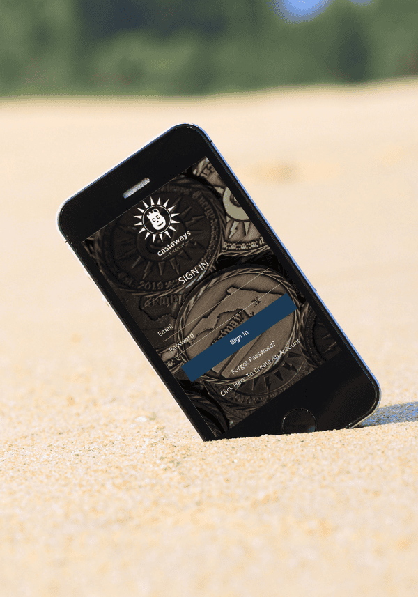 Castaways Energy mobile app login screen displayed on a smartphone resting on sandy beach, highlighting easy access to solar solutions.