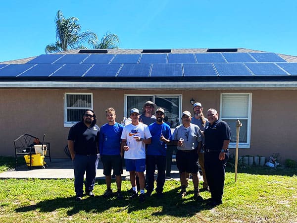 Castaways Energy team standing in front of a home installed with solar.