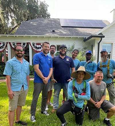 Castaways team photo in front of a home with solar installation.
