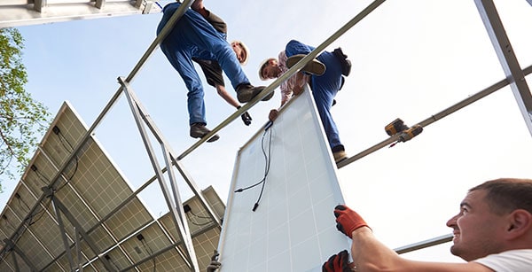 Solar installation experts efficiently deploy panels for large-scale solar farms.