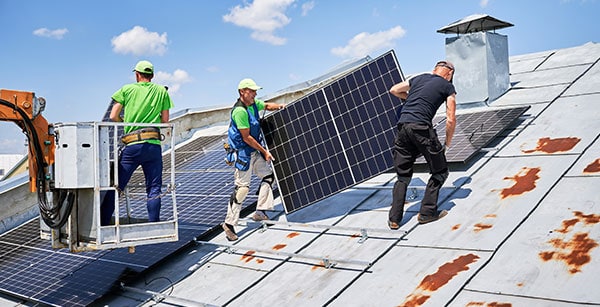 Solar installation experts efficiently deploy panels on a business building.