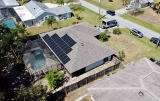 Aerial view of a house with solar panels on the roof