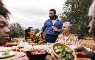 Castaways Energy sustainable Thanksgiving gathering outdoors with family sharing a meal and celebrating eco-friendly living