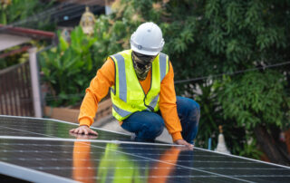 Castaways Energy technician performing solar panel maintenance on a Florida rooftop, ensuring system efficiency and long-term performance
